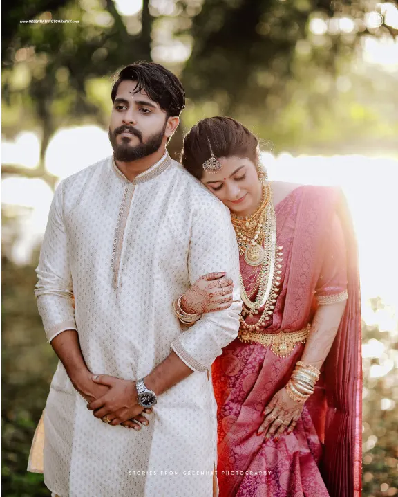 Bride and groom embracing in traditional wedding attire, intimate wedding in Trivandrum by GreenHat Photography